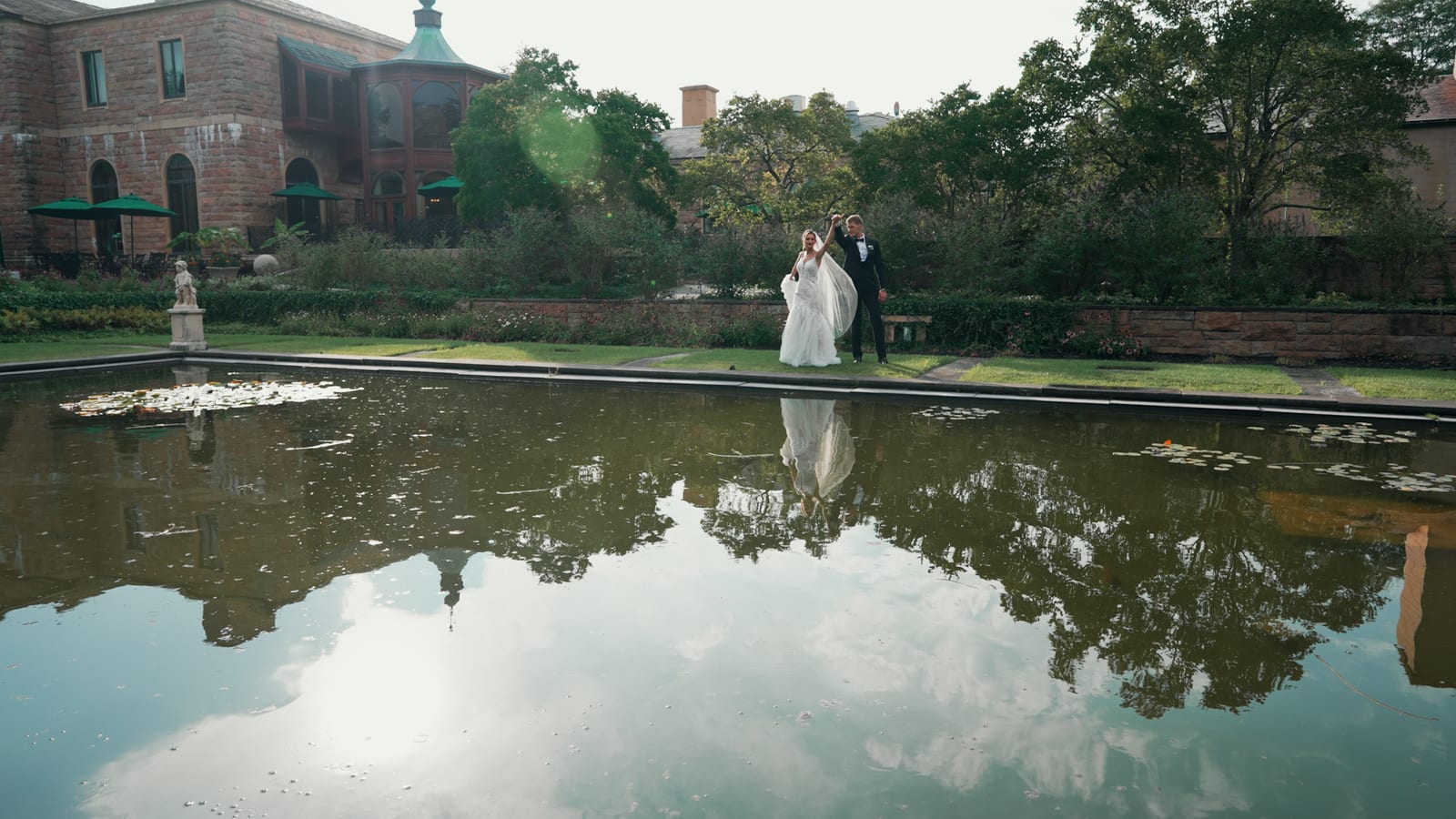 Jasna Polana Wedding Videography Karol and Victoria celebrating beside the reflecting pool
